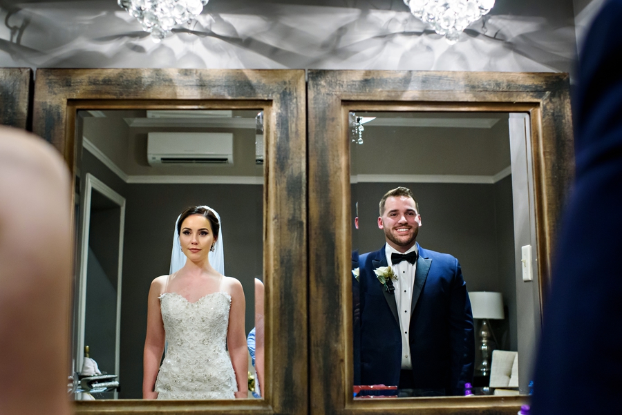 A bride and groom in the mirror.